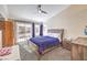 Cozy bedroom featuring carpeted floors, a ceiling fan, and a sliding glass door to the patio at 2153 Hookcross Cir, Henderson, NV 89074