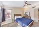 Comfortable bedroom with neutral walls, a ceiling fan, and a large window at 2153 Hookcross Cir, Henderson, NV 89074