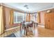 Bright dining room with wood floors, modern lighting, and large windows at 2153 Hookcross Cir, Henderson, NV 89074