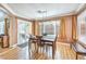 Bright dining room with wood floors, modern lighting, and sliding glass doors at 2153 Hookcross Cir, Henderson, NV 89074