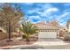 Charming single-story home with a well-manicured lawn and a two-car garage at 2153 Hookcross Cir, Henderson, NV 89074