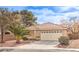 Charming single-story home with a well-manicured lawn and a two-car garage at 2153 Hookcross Cir, Henderson, NV 89074