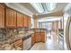 Traditional kitchen with granite countertops, stainless steel appliances, and a view into the dining area at 2153 Hookcross Cir, Henderson, NV 89074