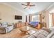 Cozy living room featuring wood flooring, a ceiling fan, and comfortable seating at 2153 Hookcross Cir, Henderson, NV 89074