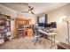 Well-organized home office with built-in shelving, a ceiling fan, and a large window at 2153 Hookcross Cir, Henderson, NV 89074