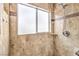 Modern tiled shower featuring a built-in shelf and a rainfall shower head at 2153 Hookcross Cir, Henderson, NV 89074