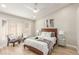 Bright bedroom featuring neutral walls, wood-look floors, large windows, and contemporary furnishings at 2401 Rockford St, Las Vegas, NV 89134