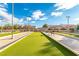 Community bocce ball court featuring a green synthetic surface, benches and shade covers at 2401 Rockford St, Las Vegas, NV 89134