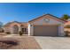 Inviting exterior view of a single-story home with attached garage and desert landscaping at 2401 Rockford St, Las Vegas, NV 89134