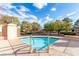 Community hot tub with clear water and a blue tiled trim, surrounded by mature landscaping at 2401 Rockford St, Las Vegas, NV 89134