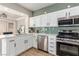 Modern kitchen with white cabinets, stainless steel appliances, and an attractive green subway tile backsplash at 2401 Rockford St, Las Vegas, NV 89134