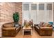 Lobby area with leather sofas, wood floors, and stone accent wall, creating a warm and inviting atmosphere at 2401 Rockford St, Las Vegas, NV 89134