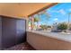 View from a balcony featuring decorative flooring, railing, and mature trees at 2451 N Rainbow Blvd # 2139, Las Vegas, NV 89108