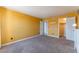 Bedroom with carpet, yellow walls, a closet and bathroom doors at 2451 N Rainbow Blvd # 2139, Las Vegas, NV 89108