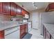 A bright kitchen featuring stainless steel appliances, granite countertops, and dark wood cabinets at 2451 N Rainbow Blvd # 2139, Las Vegas, NV 89108