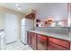 View of kitchen with stainless steel refrigerator and adjacent breakfast bar open to another living space at 2451 N Rainbow Blvd # 2139, Las Vegas, NV 89108