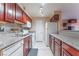 A bright kitchen featuring stainless steel appliances, granite countertops, and dark wood cabinets at 2451 N Rainbow Blvd # 2139, Las Vegas, NV 89108