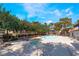 A community pool and spa surrounded by mature trees on a sunny day at 2451 N Rainbow Blvd # 2139, Las Vegas, NV 89108