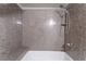 A close-up view of the shower with a built-in seat and shower head with a shelf at 2451 N Rainbow Blvd # 2139, Las Vegas, NV 89108