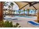 Beautiful community pool area with palm trees, lounge chairs and shaded cabanas at 2844 Copper Wind Ln # 4, Las Vegas, NV 89183