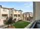 Exterior shot featuring a manicured lawn and multi-story condos with balconies under a blue sky at 2844 Copper Wind Ln # 4, Las Vegas, NV 89183