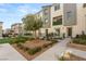 View of the townhouse exterior showing landscaping, entryways and a small green space at 2844 Copper Wind Ln # 4, Las Vegas, NV 89183