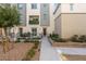 Exterior view of a modern multi-story home with a small yard, a balcony and landscaping at 2844 Copper Wind Ln # 4, Las Vegas, NV 89183