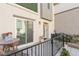 Outdoor patio area with table, chairs, black metal railing, and a sliding glass door at 2844 Copper Wind Ln # 4, Las Vegas, NV 89183