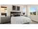 Well lit main bedroom featuring plush bed, accent tables, and large windows at 29 Faro De Marbella Ct, Henderson, NV 89011