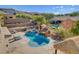 Private backyard with a sparkling pool, rock waterfall feature, jacuzzi, and lush landscaping at 3 Chenal Pass, Henderson, NV 89052