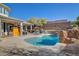 Outdoor living space featuring a pool with waterfall, lounge chairs, and a shaded dining area at 3 Chenal Pass, Henderson, NV 89052