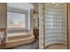 Bathroom featuring a soaking tub, glass block shower, and vanity at 3 Chenal Pass, Henderson, NV 89052