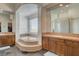 Bright bathroom featuring a tub, glass block shower, double sinks, and plenty of counter space at 3 Chenal Pass, Henderson, NV 89052