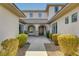 A covered walkway leads to the front door, accentuated by beautiful landscaping and architectural details at 3 Chenal Pass, Henderson, NV 89052