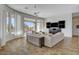 A living room features tile floors, a ceiling fan, modern furniture, and views of the outdoor space at 3 Chenal Pass, Henderson, NV 89052