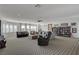 Expansive living room with a wall of windows, multiple seating options, and a built-in bookcase at 3 Chenal Pass, Henderson, NV 89052