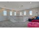 Spacious loft area with bright lighting, soft carpet, windows, and comfortable seating at 3 Chenal Pass, Henderson, NV 89052