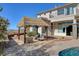 Backyard seating area with a covered patio, comfortable seating, and scenic views at 3 Chenal Pass, Henderson, NV 89052