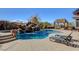 Beautiful pool with a rock waterfall, lush landscaping, and a relaxing lounge area at 3 Chenal Pass, Henderson, NV 89052