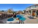 Inviting pool area with a rock waterfall, spa, and comfortable lounge chairs at 3 Chenal Pass, Henderson, NV 89052