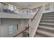 Elegant staircase with wood and white railings, carpeted steps, and an open, airy landing at 3 Chenal Pass, Henderson, NV 89052