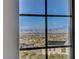 Window view showcasing a cityscape, mountains, and a residential neighborhood with solar panels at 3 Chenal Pass, Henderson, NV 89052