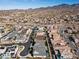 Scenic aerial shot showcases a well-planned community with uniform houses, desert landscaping, and mountain backdrop at 3025 Merlesco Ave, Henderson, NV 89044