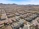 Sprawling aerial perspective of a residential area showcasing diverse homes with landscaped yards and scenic surroundings at 3025 Merlesco Ave, Henderson, NV 89044