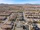 Extensive aerial shot of a community with a focus on modern homes, organized streets, and desert landscape at 3025 Merlesco Ave, Henderson, NV 89044