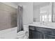 Bathroom featuring a shower/tub combination, and a single sink vanity with gray decorative walls at 3025 Merlesco Ave, Henderson, NV 89044