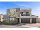 Two story home with two car garage, stone accent wall, landscaping, and covered patio at 3025 Merlesco Ave, Henderson, NV 89044