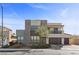 Striking two-story home featuring stone accents, a balcony, a three-car garage and landscaped front yard at 3025 Merlesco Ave, Henderson, NV 89044