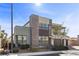 Contemporary two-story home with a stone accent wall and a three-car garage and manicured landscaping at 3025 Merlesco Ave, Henderson, NV 89044