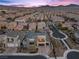 Modern two-story home with a private balcony, desert landscaping, and two-car garage under a stunning dusk sky at 3025 Merlesco Ave, Henderson, NV 89044